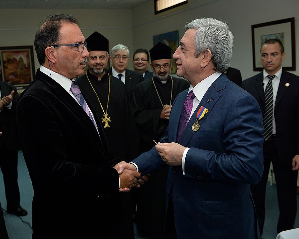 Simon Aynedjian shaking hands with President Serzh Sargsyan after receiving the medal